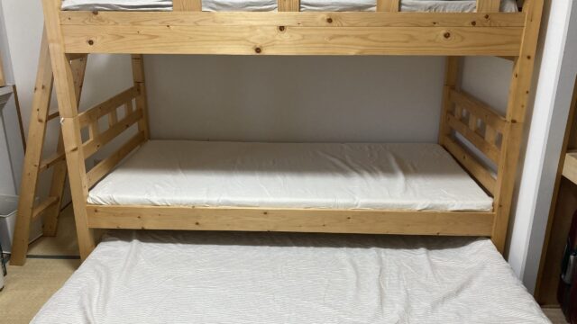 リネンのシーツを敷いた3段ベッド